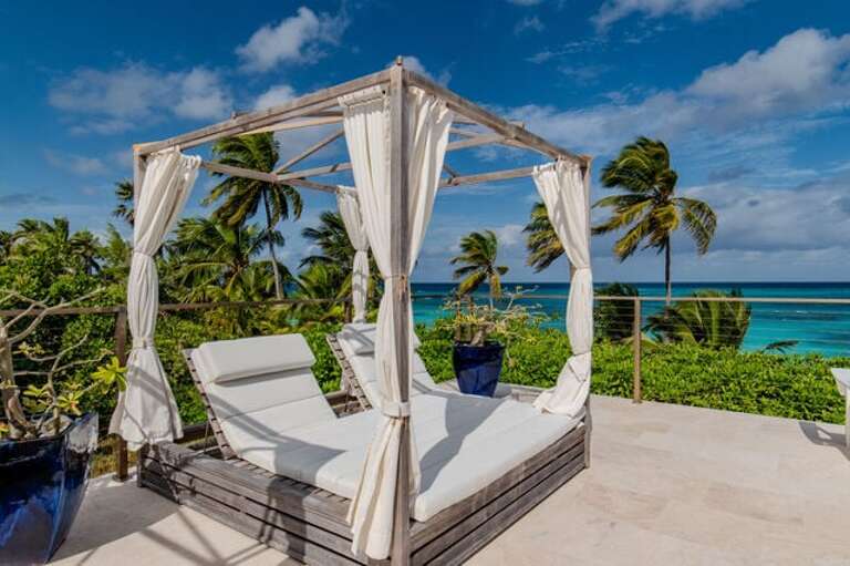 Sunbathe on the oceanfront poolside sunbed.
