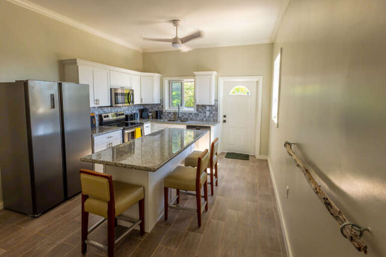 Fully equipped Kitchen with additional island seating.
