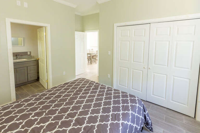 The large master bedroom has a queen bed, large closet and an en-suite bathroom with bathtub and shower.