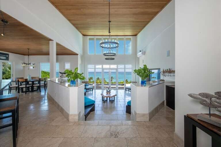 The great room, with 20-foot ceilings and a wall of tall glass Nana doors