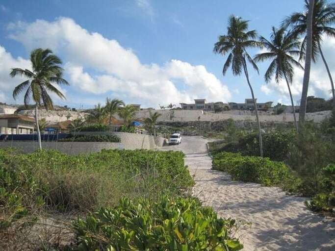 View of the hilltop villas from the beach. (Villas are above the white SUV)