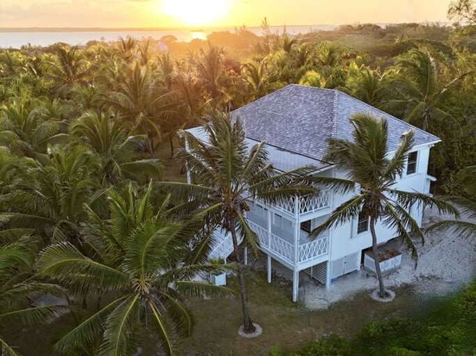 The Guest House at Hibiscus Hill seen from above as the sun dips into the bay The Guest House at Hibiscus Hill seen from above as the sun dips into the bay