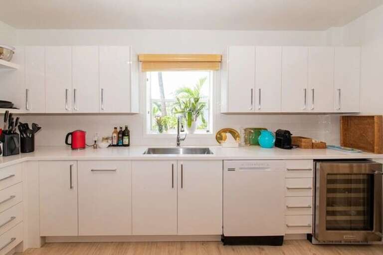 Gourmet kitchen, where culinary dreams come to life amidst sleek Samsung appliances and custom soft-close cabinets.