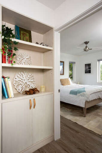The second bedroom has custom built cabinets.