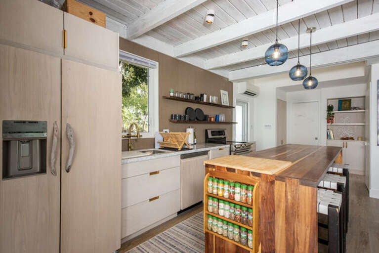 A full island kitchen, double oven and stove, full size refrigerator, and all the appliances:  Air fryer, microwave, blender, toaster, coffee maker, kettle etc.