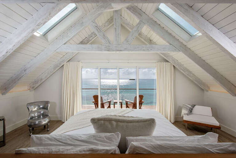 Master Cottage Bedroom suite has king size bed which has spectacular ocean views through a wall of glass, including a private deck.