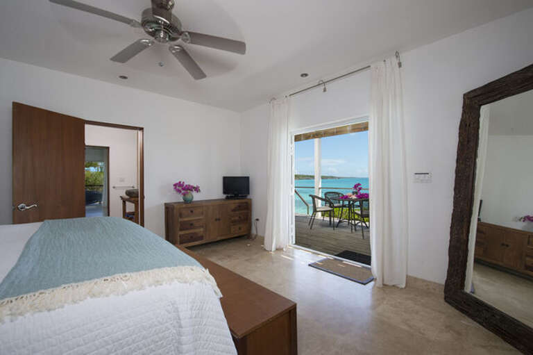 Touch of Class Villa's 1st floor has 2 bedrooms. The 1st, shown here, is equipped with a king-size bed.  Both rooms offer breathtaking ocean views.