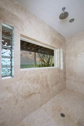 The Villa's downstairs bathroom shower with an ocean view