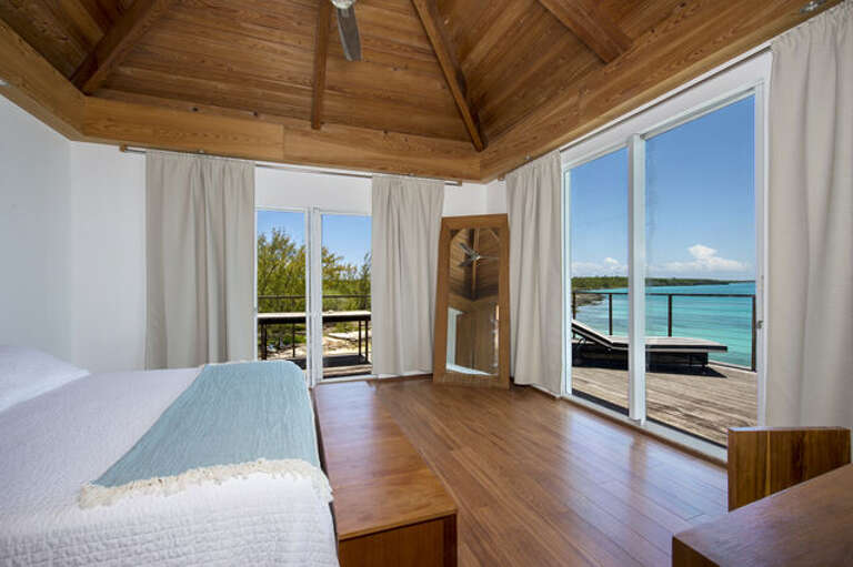 Wake up to the ocean view from our king size bed in the top floor master bedroom of Touch of Class Villa.