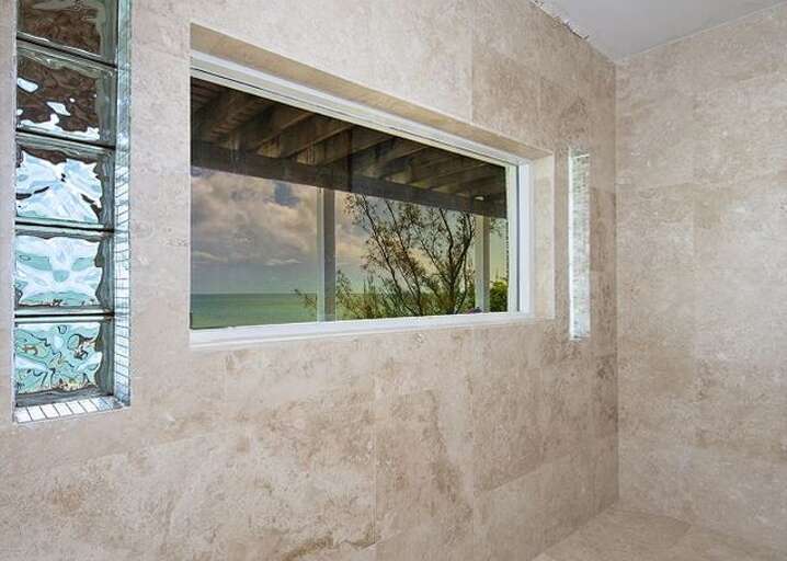 Downstairs bathroom shower with an ocean view
