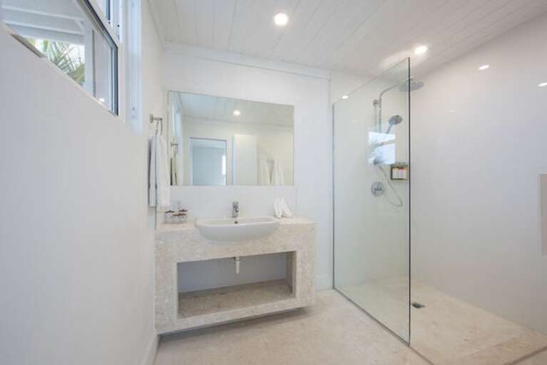 Bath with walk-in shower.