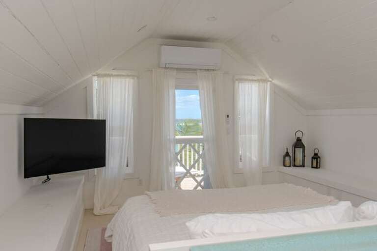 The third bedroom takes up the entire second floor. It has a king bed, an en-suite full bath, and three private balconies with spectacular beach and ocean views.