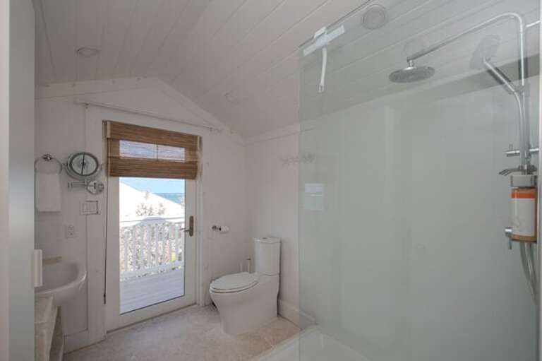 Third-floor en-suite full bath with walk-in shower and private balcony.