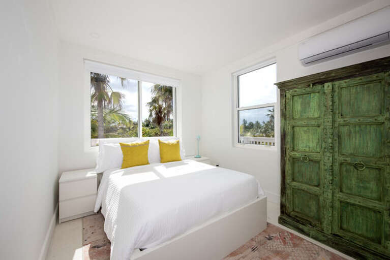 Lower level bedroom #2 with a full bed, en-suite full bath, and ocean view.