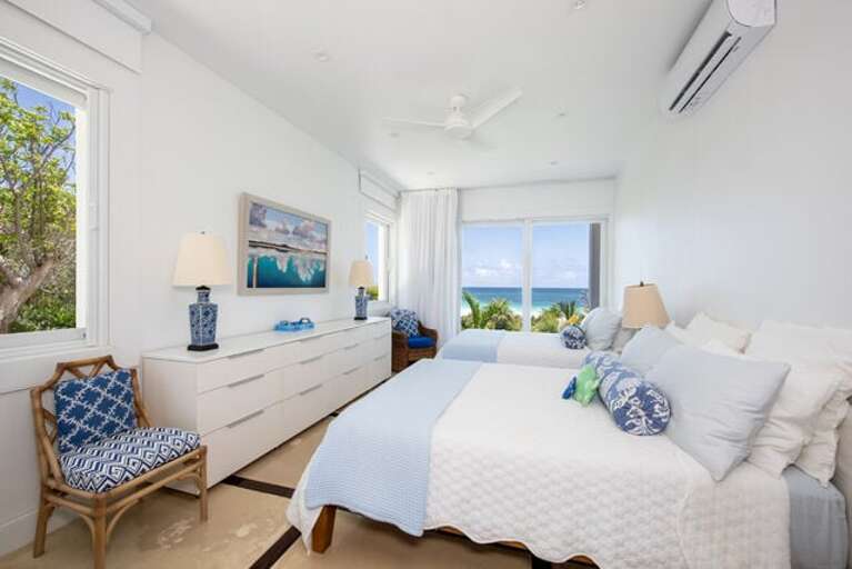 Guest Bedroom One with two queen beds, en-suite full bath, and a beautiful ocean view.