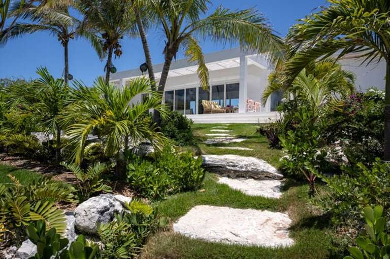 Lush grounds with stone pathway.