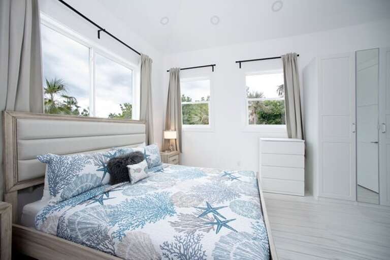The master suite is furnished with a king bed and has a full en-suite bath with a walk-in shower.