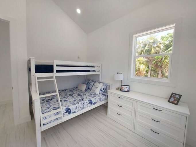 The guest bedroom is furnished with a twin XL-over-queen bunk bed and is right next to the second full bath.