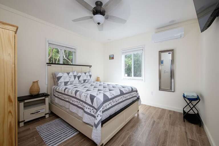 Bedroom with a queen sized bed and one full bath