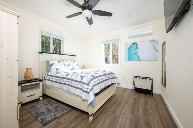 Bedroom with a queen sized bed and one full bath