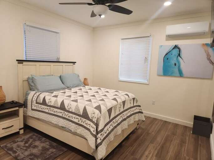 Bedroom with a queen sized bed and one full bath