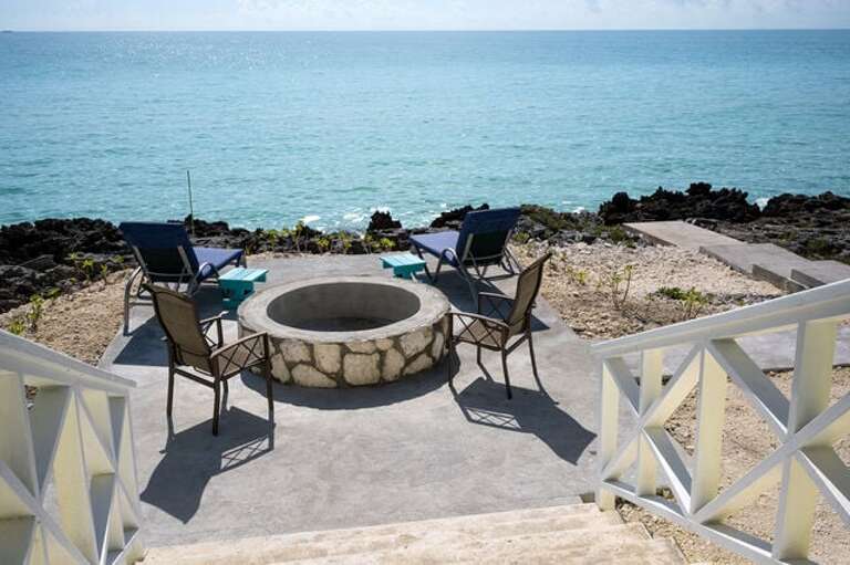 Guest Cottage patio with fire-pit and outdoor seating.