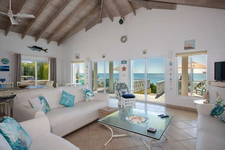 The living area, which also enjoys sweeping ocean views through a wall of glass, has three sofas including a queen-sized sleeper.