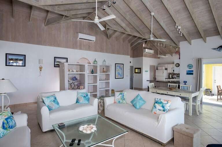 The living area has three sofas including a queen-sized sleeper.