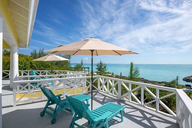 Main House large sea-front porch furnished with Adirondack chairs.