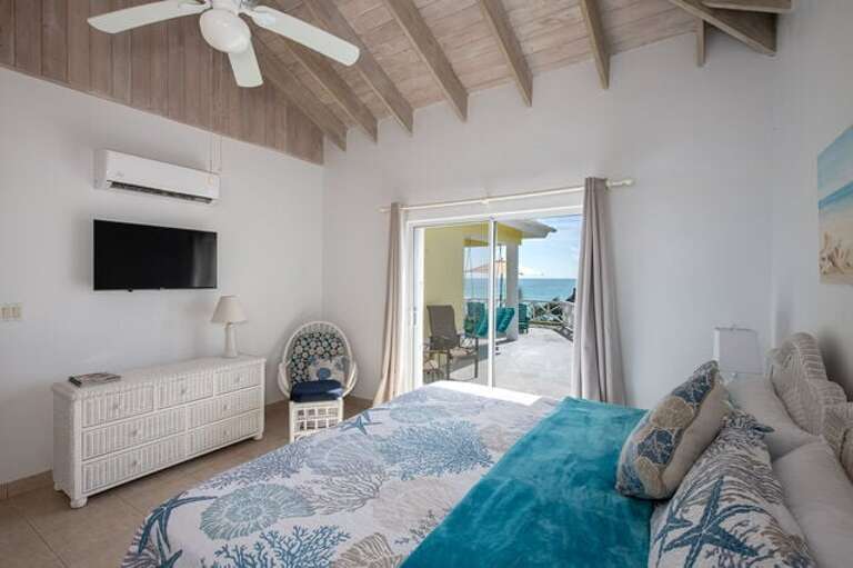 Master suite has a sliding door which opens onto its own private patio overlooking the seas.