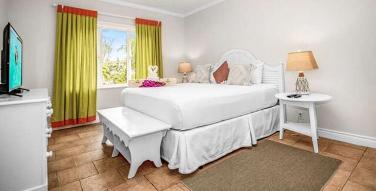 Bedroom with king size bed and garden view.