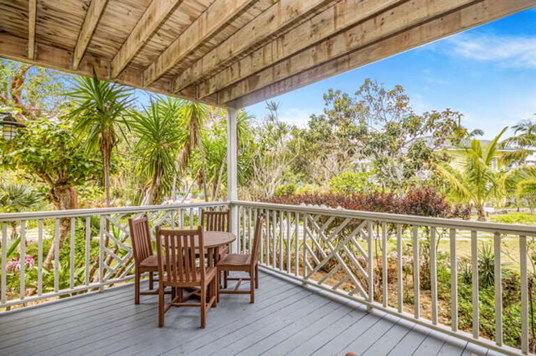 Covered porch with garden view and a dining option.