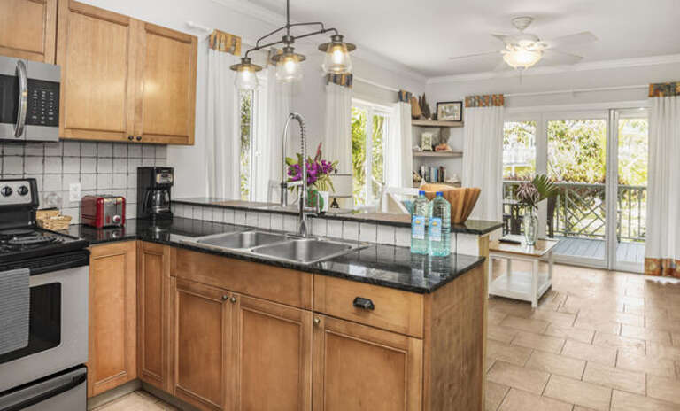 Fully equipped kitchen with bar seating.