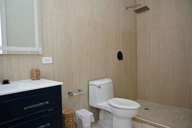 Bath with walk in shower.