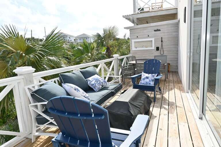 The deck has a private outdoor shower, conversation seating with a firepit, and an outdoor dining table.