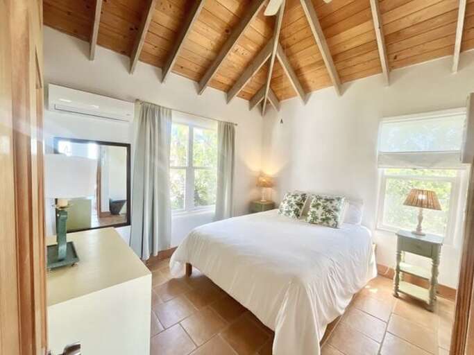 Guest Loft (Upstairs): A cozy Queen bed with easy access to the deck.