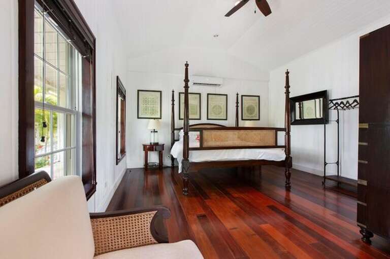 Another Main House master bedroom suite with king bed and en suite bath.