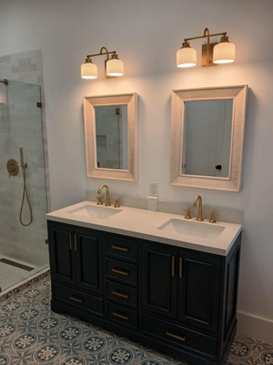 Primary bath with dual sinks and walk-in shower.