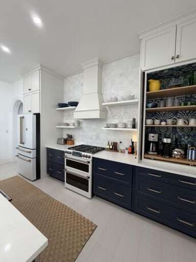 Luxurious chef's kitchen finished in quartz and stainless steel.
