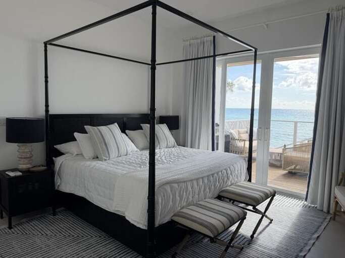Second master bedroom with king bed, en-suite bath, and ocean view.