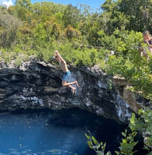 Cliff jumping at the Ocean Hole, Rock Sound.