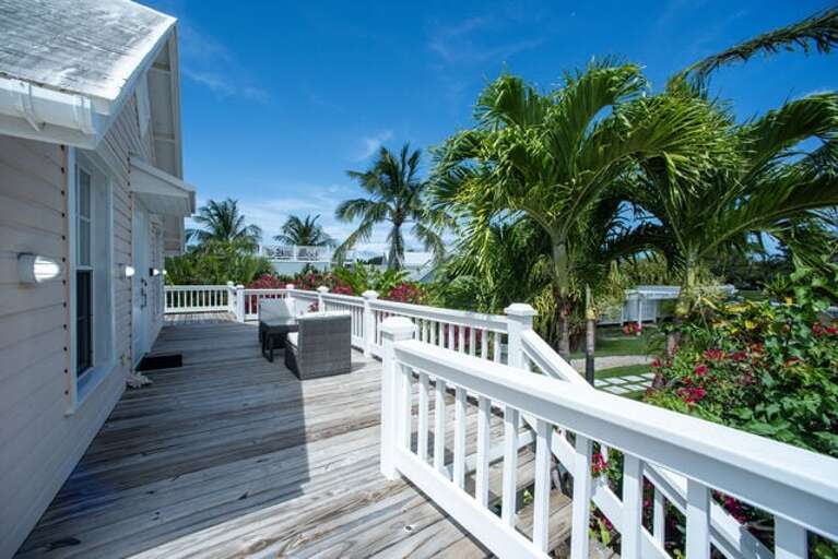 The veranda, furnished for lounging and dining, is ideal for morning coffee or evening cocktails.