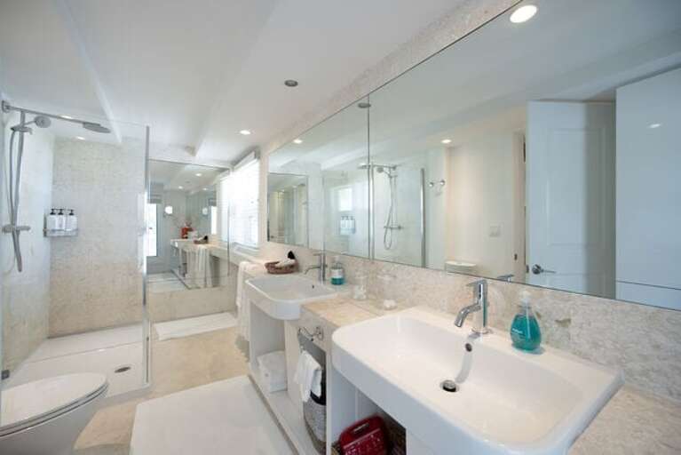 Full bath with walk-in shower shared by the third and fourth bedrooms.