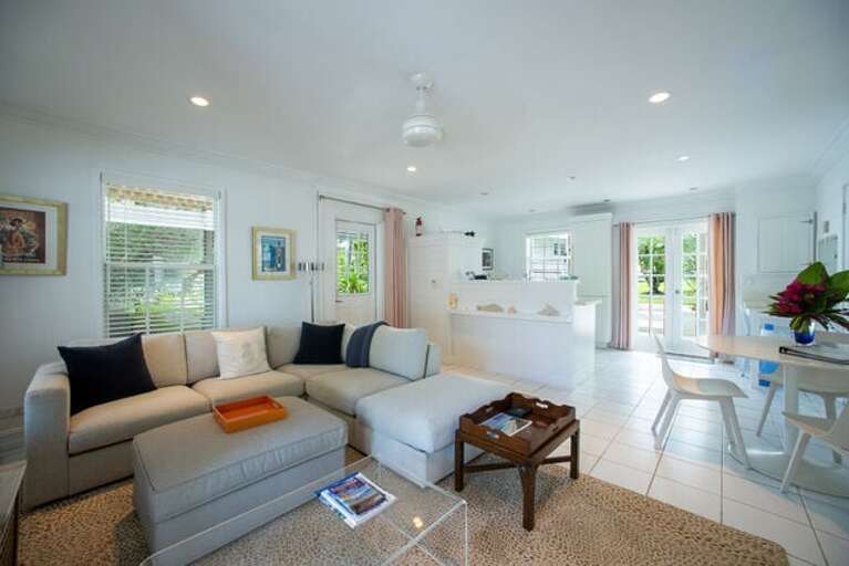 Open-plan living and dining area with French doors to a large patio.