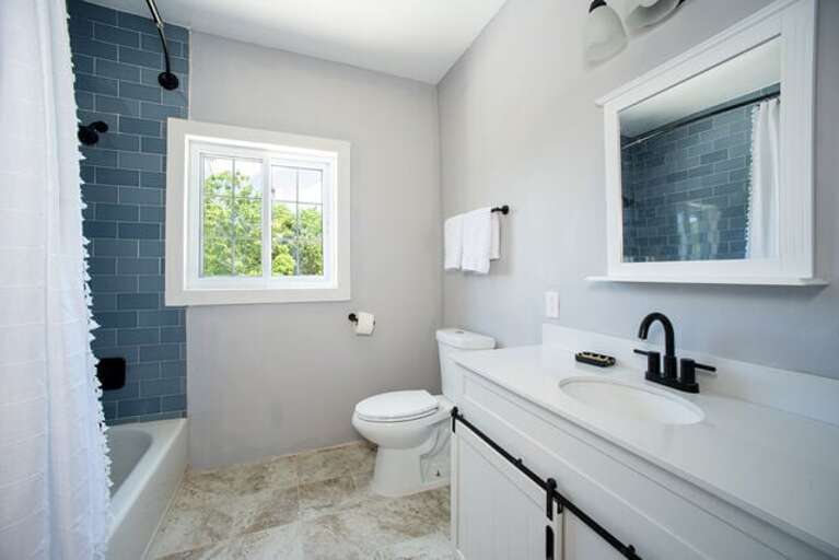 Full bath with a shower/tub combination shared by the second and third bedrooms.