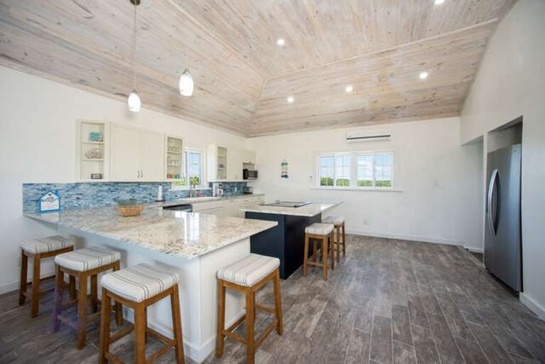 Modern island kitchen finished in quartz and stainless steel.  Fully equipped with everything you need to prepare meals with ease.