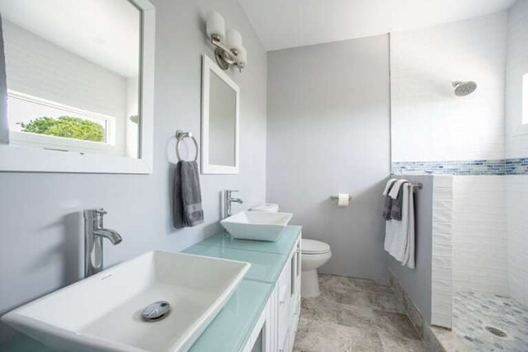 Primary ensuite full bathroom with double vanity and walk-in shower.
