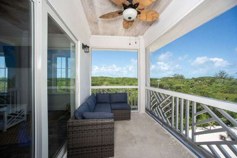 Our top-floor screened balcony just off the great room, perfect for morning coffee.  Furnished for both lounging and dining.