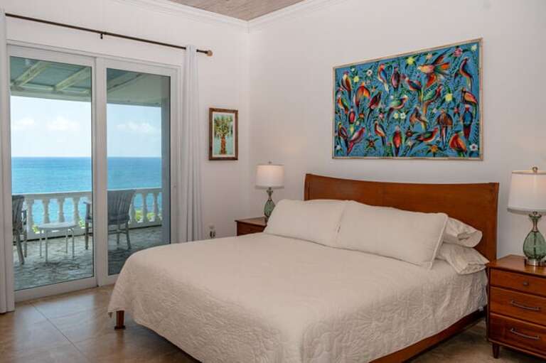 Bedroom One with king size bed and an ensuite full bath. Every bedroom has its own mini split air conditioning unit.