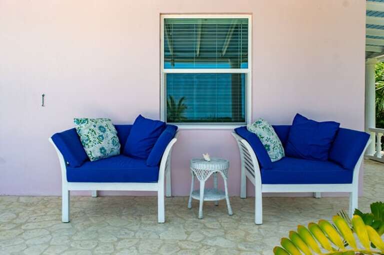 Covered porch seating by pool.